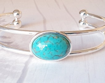 Pulseira rígida com cabochão de vidro turquesa, joia marcante banhada a prata.