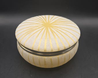 Vintage decorative lidded trinket box features a cream and gold starburst design