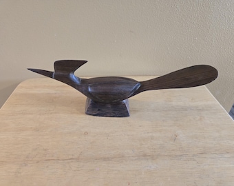 Vintage Hand-Carved Wooden Roadrunner Figurine featuring a smooth, dark wood grain and an integrated rectangular base