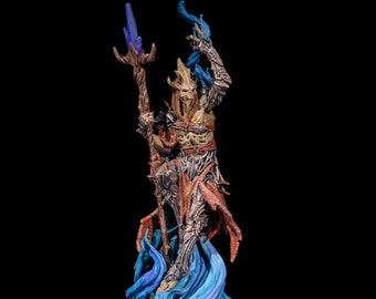May include: A detailed miniature figurine of a skeletal creature with a staff, wearing a red and brown robe and armor, standing on a blue and purple swirling base.