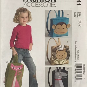 May include: A sewing pattern for four different children's backpacks. The backpacks are designed to look like animal faces. The pattern includes a monkey, lion, cat, and wolf. The pattern is called McCall's Fashion Accessories and the pattern number is M5341.