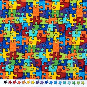 May include: A colorful fabric with a repeating pattern of puzzle pieces in shades of red, orange, yellow, green, blue, and purple. The puzzle pieces are outlined in black.