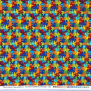 May include: A colorful fabric with a repeating pattern of puzzle pieces in shades of red, orange, yellow, green, blue, and purple. The puzzle pieces are outlined in black and have a textured appearance.