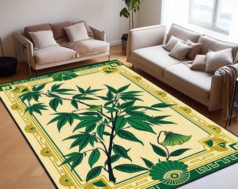 May include: A rectangular area rug with a botanical design. The rug features a central image of a tree with green leaves and a dark trunk, set against a cream-colored background. The border is green with geometric and floral patterns.