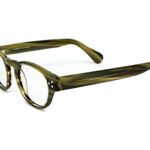 May include: Green tortoise shell eyeglasses with a classic round frame and clear lenses.