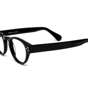 May include: Black round-framed eyeglasses with a classic design. The frames are made of a thick, durable plastic.