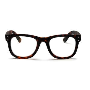 May include: A pair of eyeglasses with a classic, rectangular frame in a tortoiseshell pattern. The glasses have clear lenses and are set against a white background. The temples are dark brown and attached to the frame with small silver rivets.