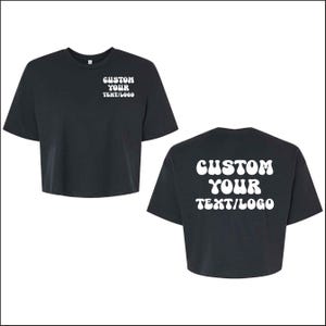 May include: Black cropped t-shirts with white text that reads "CUSTOM YOUR TEXT/LOGO" on the front and back. The shirts have short sleeves and a crew neck.