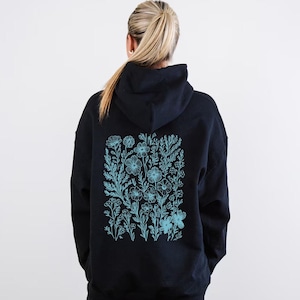 May include: Black hoodie with a blue floral design on the back.