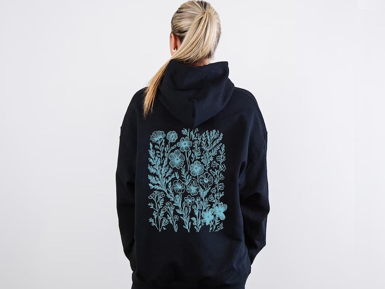 May include: Black hoodie with a blue floral design on the back.