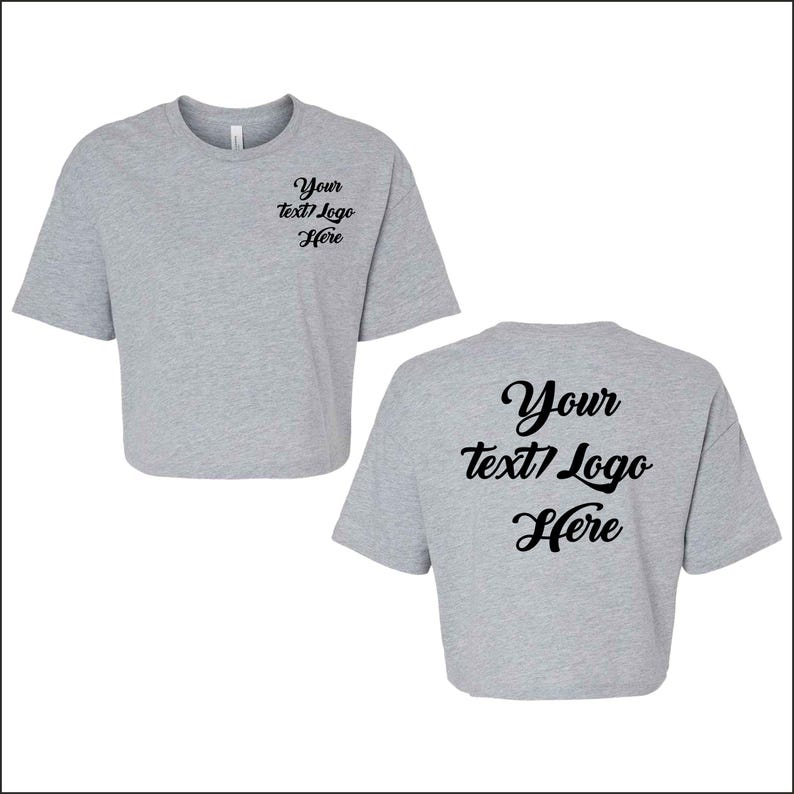 May include: Two light gray crop tops. The front of the shirt has the text "Your text/Logo Here" in black script. The back of the shirt has the same text. The shirts have short sleeves and a crew neck.