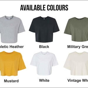 May include: A selection of six cropped t-shirts in various colors: athletic heather, black, military green, mustard, white, and vintage white. The text "AVAILABLE COLOURS" is at the top of the image, with each shirt displayed below its color name.