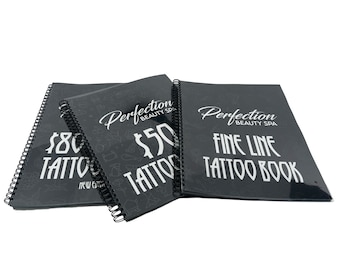 May include: Three black spiral bound books with white text. The top book says "Perfection Beauty Spa Fine Line Tattoo Book". The middle book says "$50 Tattoo" and the bottom book says "$80 Tattoo New Edition".