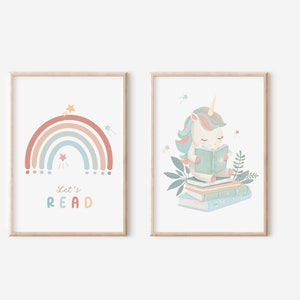 May include: Two framed art prints. One features a pastel rainbow with stars and the text "Let's READ." The other print shows a unicorn reading a book atop a stack of books, surrounded by leaves. Both prints have a light wood frame.