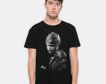 May include: Black t-shirt with a graphic print of a monkey in a warrior pose. The monkey is in black and white and has a fierce expression. The text "孫悟空" is printed on the shirt.