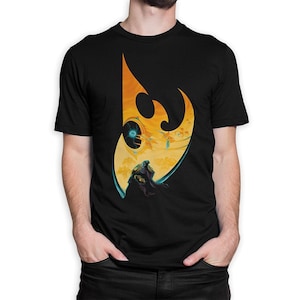 May include: Black t-shirt with a yellow and orange graphic of a stylized crescent moon with a figure standing in front of it.