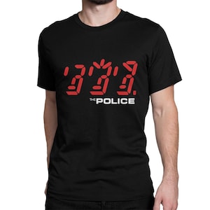 May include: Black t-shirt with a red digital display graphic that reads "Every Breath You Take" and the text "The Police" below.
