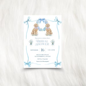 May include: A light blue and white bridal shower invitation with watercolor illustrations of two dogs and floral accents. The invitation includes the text "Bridal Shower" and event details.