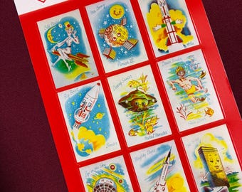 May include: A sticker sheet with a red border featuring vintage-style illustrations of rockets, space stations, and other space-themed images. The sheet includes the text "@RecycLoves sticker sheet" at the top. The illustrations are colorful and reminiscent of retro science fiction.