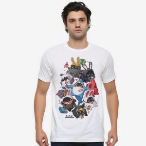 May include: White t-shirt with a vibrant cartoon illustration of animal characters, such as rabbits and a shark. The design uses multiple colours and details, with Japanese text at the bottom. The shirt is worn by a person.
