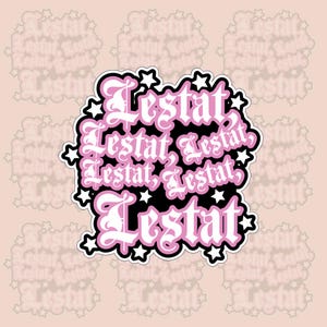 May include: A black and pink sticker with the word "Lestat" repeated multiple times in a gothic font. The sticker is surrounded by white stars.