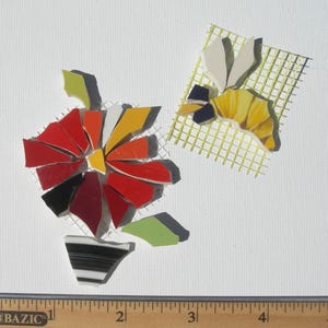 May include: A mosaic craft kit featuring a flower design with red, orange, yellow, black, and lime green glass pieces on a white mesh backing, alongside a bee design on yellow mesh, measured by a ruler showing approximately 4.5 inches in width.
