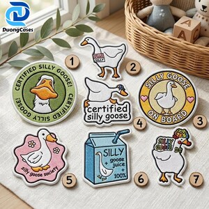 May include: Seven embroidered patches featuring goose designs. One is a green circle with a goose, one is a white goose with a name tag, one is a goose with text, one is a yellow circle with a goose, one is a pink flower shape with a goose, one is a blue juice carton, and one is a goose with a floral crown.