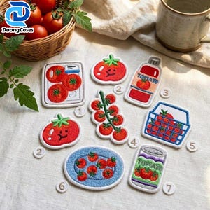 May include: A collection of seven embroidered patches featuring tomato-themed designs, including individual tomatoes, a vine, a bottle labeled Tomato, a basket, and a can labeled Tomato, each numbered with a small white circular tag for identification.