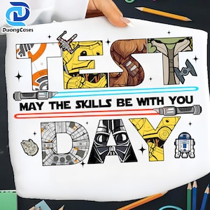 May include: White graphic featuring Star Wars characters and text. The word "TEST" is filled with images of a droid and a starfighter. The phrase "MAY THE SKILLS BE WITH YOU" is written below the word "TEST". The word "DAY" is filled with images of Darth Vader and a droid.