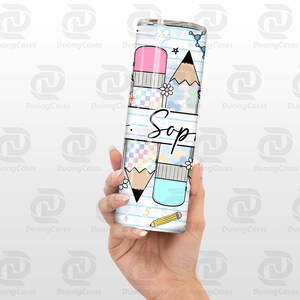 May include: A white tumbler with a school-themed design. The tumbler features illustrations of pencils, erasers, and flowers, with the name "Sop" written in cursive. The design includes a checkered pattern and the number "5".