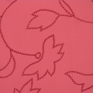 May include: A pink fabric with a repeating pattern of red embroidered leaves. The leaves are outlined with a series of small stitches.