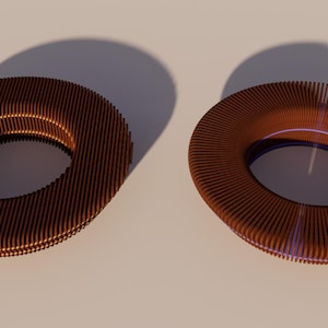 May include: Two brown, ring-shaped objects with a ribbed texture are displayed. The objects cast shadows on a light-colored surface. The rings have a circular opening in the center.