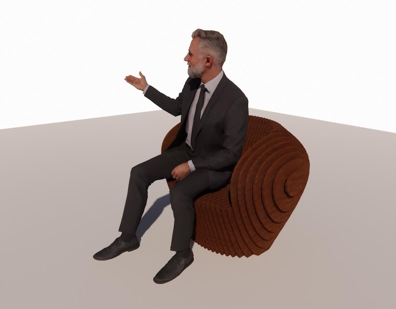 May include: A man in a dark suit sits in a brown, layered wooden chair. The chair has a unique, spiral design. The man is gesturing with his right hand, as if presenting or speaking.