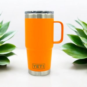 May include: Orange YETI Rambler 14 oz Mug with a stainless steel lid and handle.