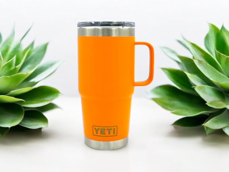May include: Orange YETI Rambler 14 oz Mug with a stainless steel lid and handle.