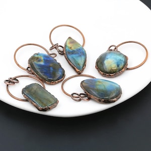 May include: Five copper wire wrapped labradorite gemstone bottle stoppers. Each stopper features a different shaped gemstone with a copper wire ring.