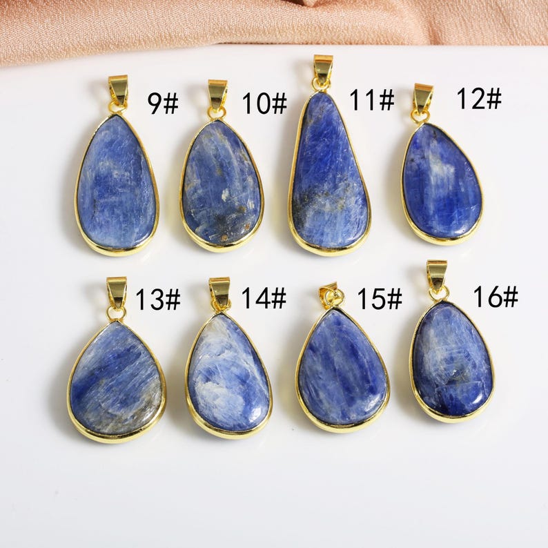 May include: Eight gold pendants with blue gemstone drops. The pendants are numbered 9 through 16.