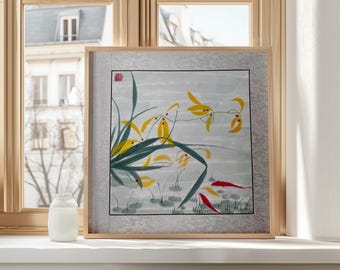 May include: A framed watercolour painting depicting yellow flowers and red fish. The artwork has a light grey background with a floral border and is set in a natural wood frame. The painting is displayed on a white windowsill.