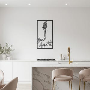 May include: Black framed wall art featuring a stylized depiction of spaghetti and the phrase "Bon Appetit" in cursive. The artwork is set against a white background, creating a striking contrast. The design is suitable for a kitchen or dining area.