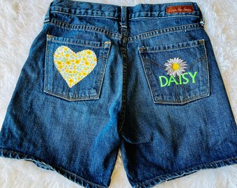 Upcycled reworked Calvin Klein denim jeans size 4 with embroidered daisy and recycled with fabric patches