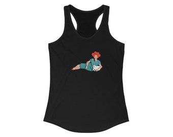 May include: A black tank top with a graphic of a woman with red hair wearing a teal dress and holding a white cat.