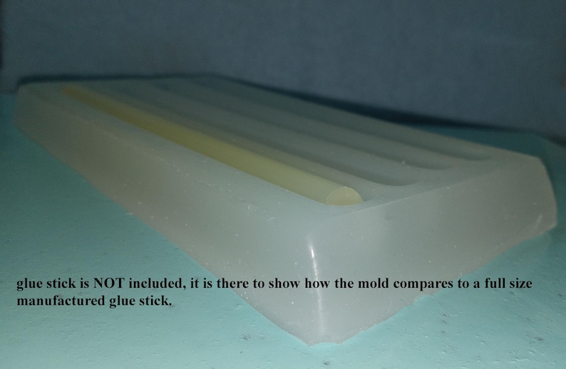 May include: A white silicone mold for making glue sticks. A glue stick is shown in the mold to demonstrate the size. "Glue stick is NOT included, it is there to show how the mold compares to a full size manufactured glue stick."