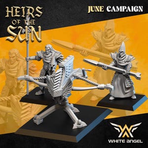 Puede incluir: Figuras en miniatura de guerreros de fantasía y una ballesta sobre bases negras. Las figuras están en varias poses, sosteniendo lanzas y armas. El texto "HEIRS OF THE SUN" y "JUNE CAMPAIGN" son visibles. También está el logo de White Angel.