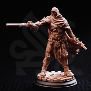 May include: A detailed brown figurine of a hooded figure in a dynamic pose, holding two flintlock pistols. The figure is clad in ornate armor and stands on a circular base with a gear-like design. The background is dark.