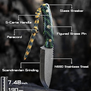 May include: A black and green handled knife with a black blade and a paracord lanyard. The blade is 7.48 inches long and made of N690 stainless steel. The handle is made of G-Carta wood and has a figured brass pin. The knife has a Scandinavian grind and a glass breaker.