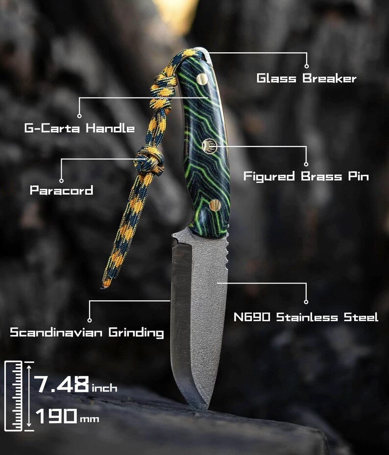 May include: A black and green handled knife with a black blade and a paracord lanyard. The blade is 7.48 inches long and made of N690 stainless steel. The handle is made of G-Carta wood and has a figured brass pin. The knife has a Scandinavian grind and a glass breaker.