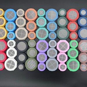 May include: A collection of 30 round, colorful, decorative, metal mesh filters. The filters are arranged in rows and columns, with each filter having a different color and design.