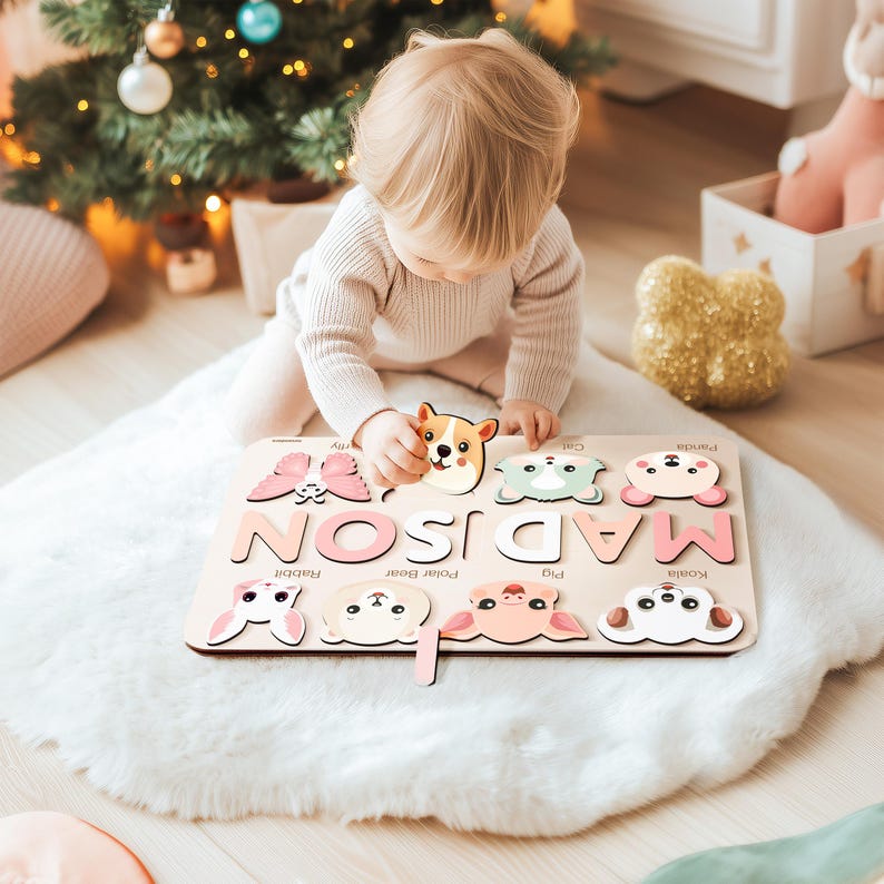 May include: A wooden puzzle with the name "MADISON" spelled out in large letters. Each letter has a different animal picture on it, including a butterfly, a cat, a koala, a pig, a polar bear, a rabbit, and a puppy. The puzzle is on a white fluffy rug.
