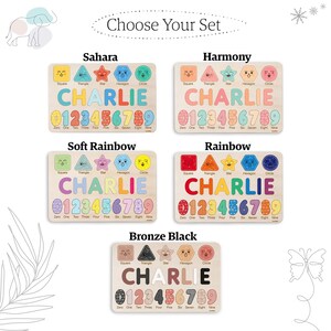 May include: Five wooden puzzle boards with different colour schemes and designs. Each board features a name, "CHARLIE", spelled out with colourful shapes, and numbers 0-9. The boards are labelled "Sahara", "Harmony", "Soft Rainbow", "Rainbow", and "Bronze Black".