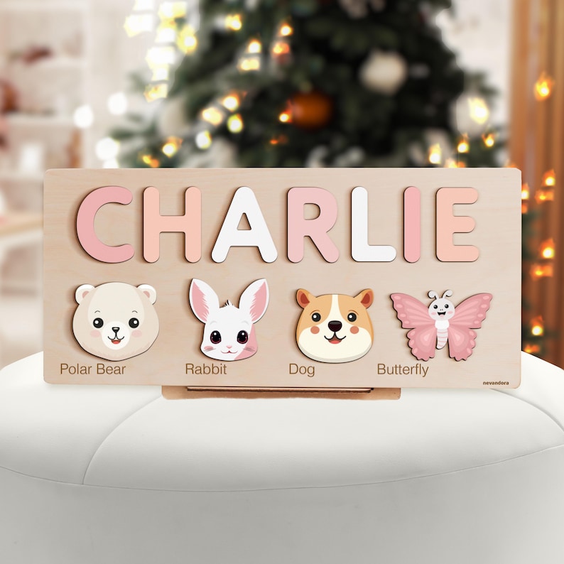May include: A wooden puzzle with the name CHARLIE in pink and white letters. The puzzle includes images of a polar bear, rabbit, dog, and butterfly.